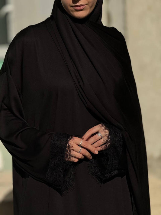 Seitliche Ansicht der Abaya Aswad Noir – fließender Schnitt, bedeckend und stilvoll getragen.