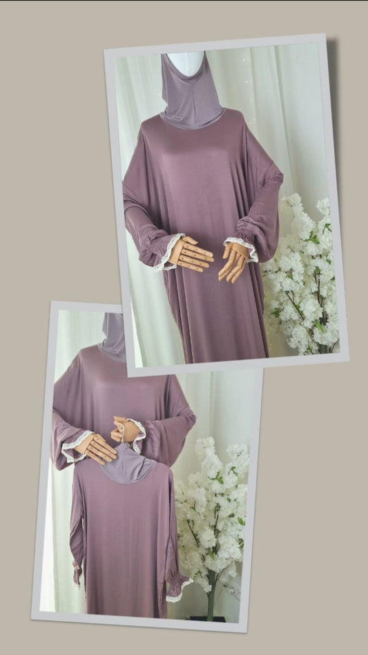 Abaya Set „Wardiyya Rose“ in zartem Altrosa, stilvoll arrangiert mit Blumendeko im Hintergrund.